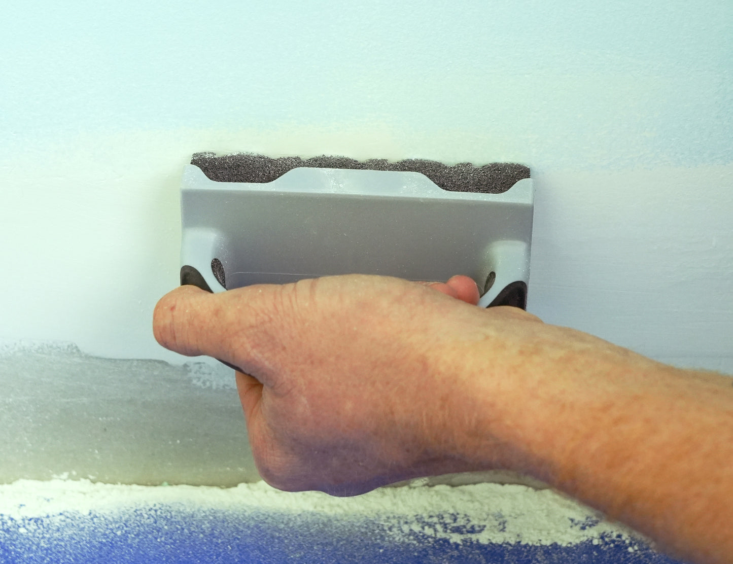 90177-Person sanding a wooden surface using ergonomic sanding sponge