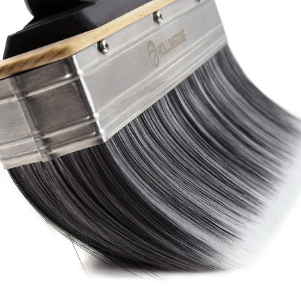 Paintbrush with black paint on a white background