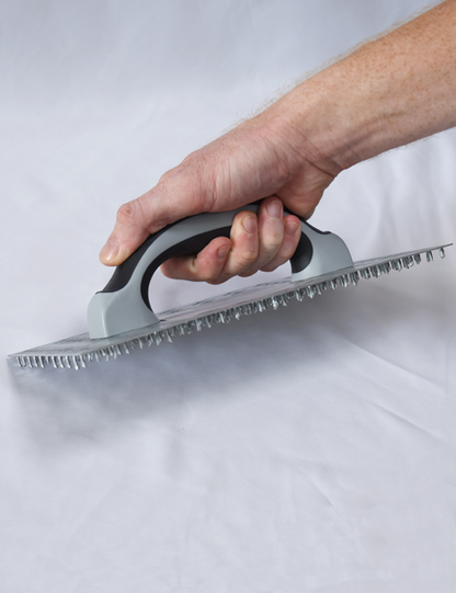 50295-Worker using render scratching float to key plaster surface before finishing