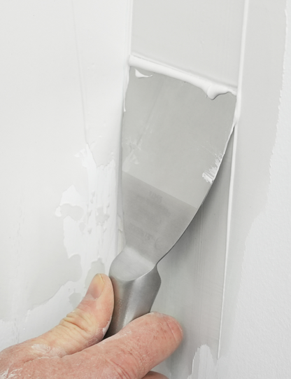 50473-Painter using 4 inch Flexible Joint Knife for patching nail holes