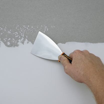 50565-Painter using angled putty knife on a wall 