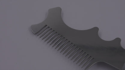 Close-up of stainless steel blade with roller slots and comb teeth